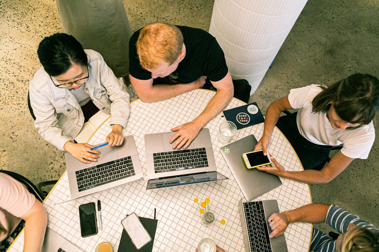 services-04 Top view of diverse team collaboratively working in a modern office setting.