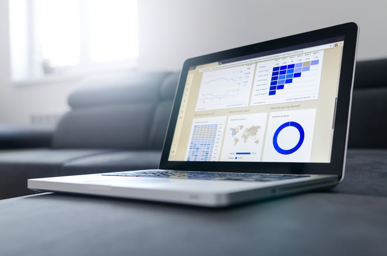about-me-img Sleek laptop showcasing data analytics and graphs on the screen in a bright room.